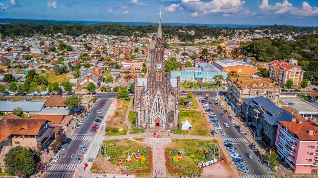 Imagem aérea da cidade de Canela com a Catedral de Pedra ao centro para ilustrar matéria sobre cidades frias no Rio Grande do Sul