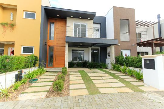 Fachada de casa de condomínio à venda com 3 quartos, 140m² em Campo Novo, Porto Alegre
