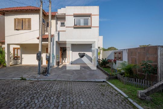 Fachada de casa de condomínio à venda com 3 quartos, 100m² em Aberta dos Morros, Porto Alegre