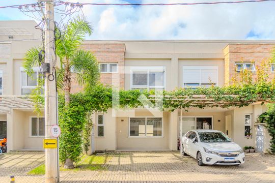 Fachada de casa de condomínio à venda com 3 quartos, 155m² em Vila Nova, Porto Alegre