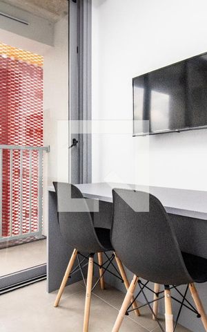 Studio para alugar com 28m², 1 quarto e sem vagaEstúdio- TV, mesa de escritório e 2 banquetas 