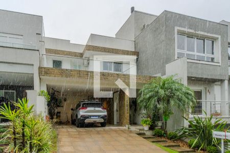 Fachada de casa de condomínio à venda com 3 quartos, 196m² em Vila Nova, Porto Alegre
