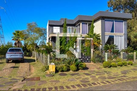 Fachada de casa de condomínio à venda com 5 quartos, 490m² em Teresópolis, Porto Alegre