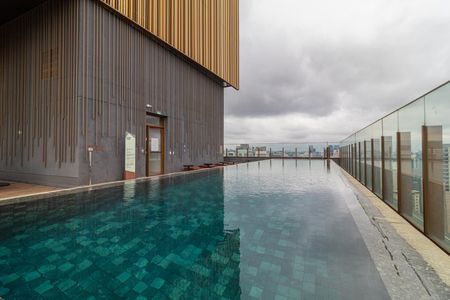 Apartamento à venda com 28m², 1 quarto e sem vagaPiscina com vista para a cidade, com paredes de tijolos e piso de pedra.