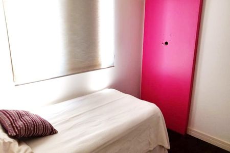 Apartamento à venda com 92m², 3 quartos e 2 vagasCama simples com colchão branco e travesseiro com estampado de linhas vermelhas e amarelas, com luz natural entrando pela janela.