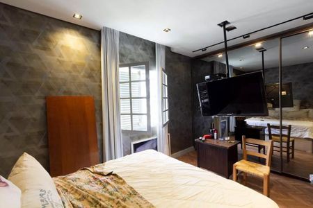 Quarto com cama, TV e móveis simples, com iluminação boa e decoração básica. de casa à venda com 3 quartos, 147m² em Vila Olímpia, São Paulo