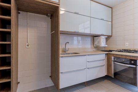 Apartamento à venda com 110m², 2 quartos e 1 vagaCozinha com móveis brancos e madeira, com geladeira e fogão, iluminada com boa qualidade de iluminação.