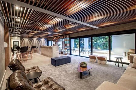 Sala com decoração moderna e iluminação natural, com vista para a varanda e jardim. de kitnet/studio à venda com 1 quarto, 29m² em Pinheiros, São Paulo