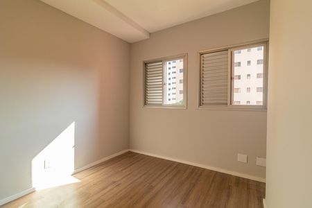 Apartamento à venda com 73m², 4 quartos e 2 vagasParede branca e piso de madeira claro, com duas janelas com persianas e luz natural entrando pela janela esquerda.