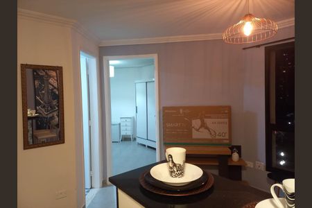 Apartamento à venda com 33m², 1 quarto e 1 vagaCasa com cozinha moderna e iluminada, com uma TV de 40 polegadas na parede.