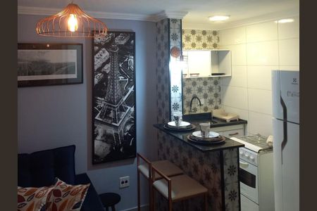 Apartamento à venda com 33m², 1 quarto e 1 vagaCozinha com geladeira, fogão e pia, com decoração simples e iluminação adequada.