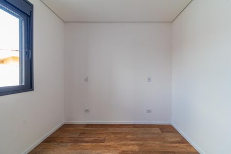 Casa à venda com 110m², 6 quartos e 2 vagasParede branca com janela e piso de madeira, sem móveis ou decoração.