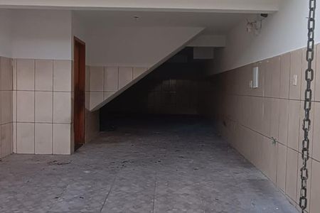 Corredor com teto inclinado e paredes revestidas de azulejos, com um chão de azulejos e uma porta de madeira. de casa à venda com 3 quartos, 138m² em Jardim do Estádio, Santo André