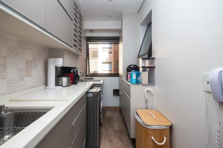 Apartamento à venda com 81m², 2 quartos e 2 vagasCozinha moderna com móveis brancos e azuis, iluminada por luz natural e artificial.