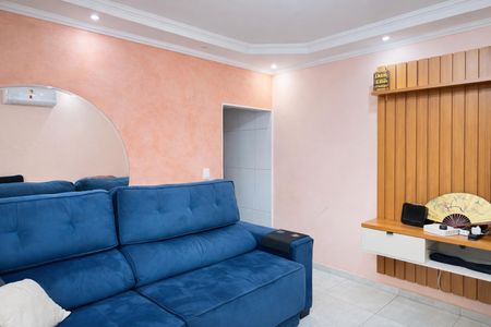 Sala de estar com sofá azul e espelho arredondado na parede. de casa à venda com 4 quartos, 136m² em Vila Francisca, Campinas