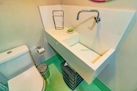 Apartamento à venda com 265m², 5 quartos e 3 vagasBanheiro com piso de azulejos, vaso sanitário e lavatório em porcelana, e espelho em metal.