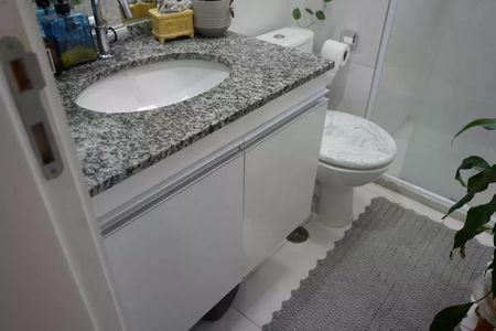 Apartamento à venda com 57m², 2 quartos e 1 vagaBanheiro com pia e vaso sanitário, com piso de porcelanato e bancada de granito.