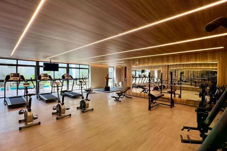 Apartamento à venda com 25m², 1 quarto e sem vagaGinásio com equipamentos de ginástica e academia, com iluminação adequada e piso de madeira.