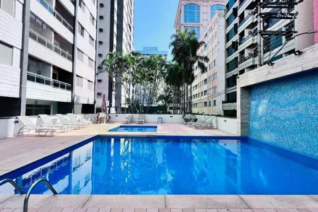 Apartamento à venda com 110m², 3 quartos e 2 vagas Apartamento à venda com 110m², 3 quartos e 2 vagasPiscina com decoração de palmeiras e edifícios ao redor.