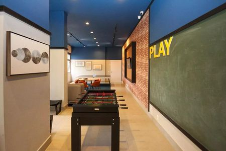 Apartamento à venda com 121m², 6 quartos e 2 vagasSala de jogos com mesa de futebol, sofás e quadra de futsal.