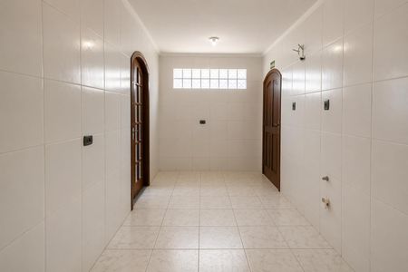 Casa à venda com 117m², 3 quartos e 3 vagas Casa à venda com 117m², 3 quartos e 3 vagasParede branca com dois portões e uma janela quadrada no meio.