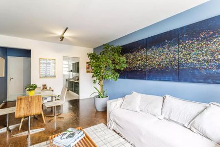 Sala com móveis modernos e pintura azul e branca, com uma mesa e cadeiras, e uma pintura de arte na parede. de apartamento à venda com 3 quartos, 105m² em Jardim America III, Várzea Paulista