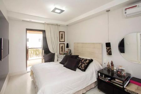 Apartamento à venda com 195m², 4 quartos e 3 vagasQuarto com cama de casal, com uma porta para a varanda, com uma TV na parede e uma janela grande.