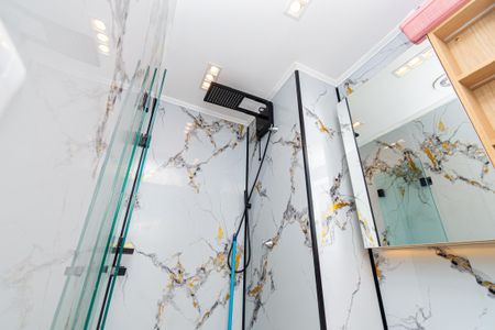 Banheiro com piso de porcelanato e paredes de mármore com decoração em ouro e prata. de kitnet/studio à venda com 0 quarto, 24m² em Pompeia, São Paulo