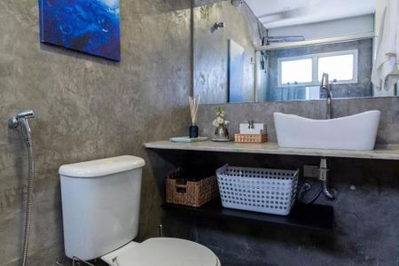 Banheiro com piso de porcelanato, pia de cerâmica e decoração minimalista. de apartamento à venda com 2 quartos, 35m² em Jardim Paulista, São Paulo