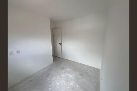Apartamento à venda com 42m², 2 quartos e 1 vaga Apartamento à venda com 42m², 2 quartos e 1 vagaQuarto com paredes brancas e piso de concreto, com porta fechada e luz natural entrando pela janela.