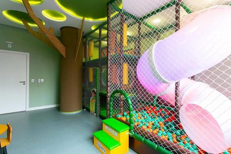 Apartamento à venda com 63m², 2 quartos e 1 vaga Apartamento à venda com 63m², 2 quartos e 1 vagaÁrea de brinquedos com escada, rede de balões e iluminação colorida.
