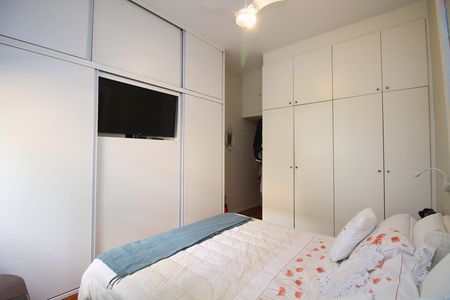 Cama com colchão branco e cobertor com desenho floral, com TV montada na parede. de apartamento para alugar com 2 quartos, 108m² em Leblon, Rio de Janeiro
