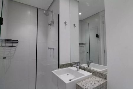 Banheiro com piso de porcelanato, pia de granito e espelho grande. de kitnet/studio à venda com 2 quartos, 23m² em Jardim das Acacias, São Paulo