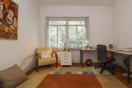Casa à venda com 110m², 2 quartos e 2 vagasSala com móveis simples e uma pintura em estilo artístico na parede.