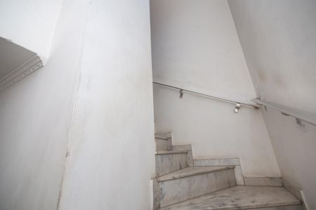 Casa à venda com 250m², 4 quartos e 2 vagas Casa à venda com 250m², 4 quartos e 2 vagasEscada branca com luzes e corrimão de metal, parede branca e teto branco.