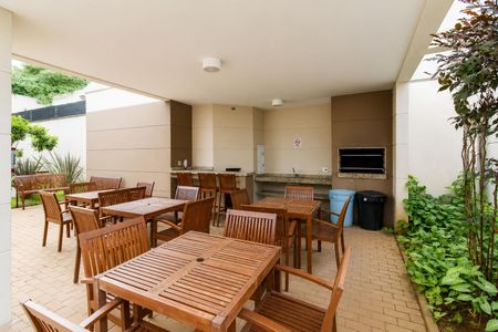 Varanda com mesas e cadeiras de madeira, com vista para o jardim e a cidade. de apartamento à venda com 2 quartos, 64m² em Freguesia do Ó, São Paulo