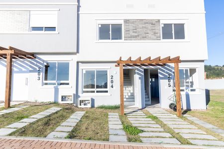 Fachada de casa de condomínio à venda com 2 quartos, 88m² em Vila Nova, Porto Alegre